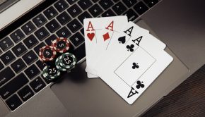 Gambling chips and playing cards on keaboard. Online casino concept.