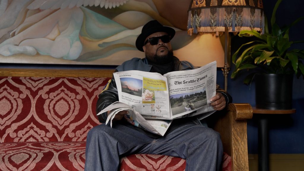 Kokane - Press Image - Reading The Seattle Times Newspaper